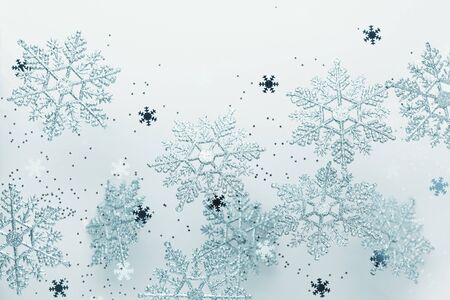 Festive winter background with decorative snowflakes in flying. Christmas, Winter or New Year...