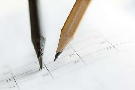 Close Up of dark and light pencils on white paper of calendar. Concept of The National Day of...
