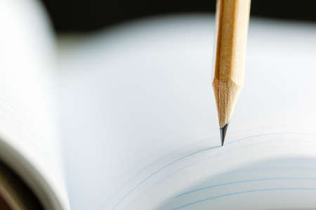 Closeup of sharp graphite pencil on white paper of notebook. Concept of The National Day of...