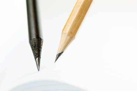 Close Up of dark and light pencils on white paper of notebook. Concept of The National Day of...