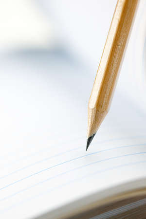 Closeup of sharp graphite pencil on white paper of notebook. Concept of The National Day of Knowledge or International literacy day.の写真素材