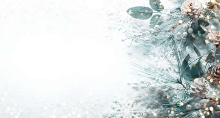 Christmas and New Year holidays concept with snowy fir branches and pine cone on light background....