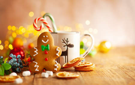 Christmas gingerbread cookies with Christmas decorations on wooden background. Traditional Christmas baking.の写真素材