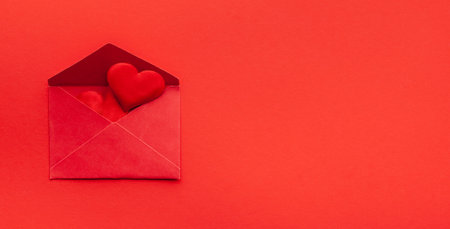 Valentine's day or Wedding romantic concept with red hearts and envelope on red