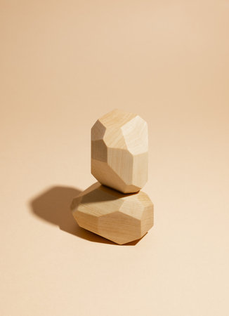 Composition of geometric balancing wooden stones. Concept of balance. Pastel background with copy space.の写真素材