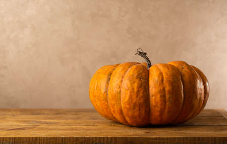 Still life of pumpkin on wooden table. Concept autumn harvest food.