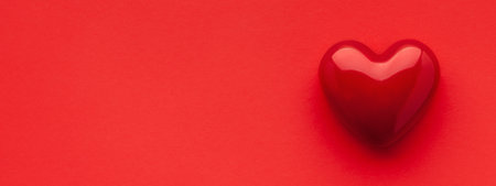 Valentine's day or Wedding romantic concept. Red heart on red background. Top view, copy spaceの写真素材