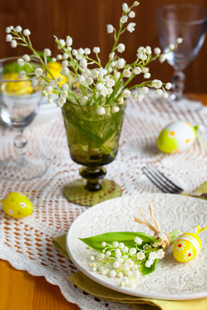 Easter table with lily-of-the-valley and eggs