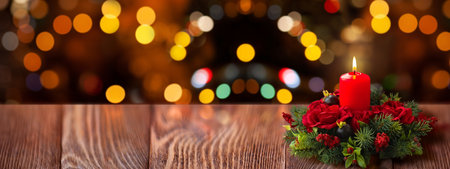 Red Christmas Candle Centerpiece on Rustic Wooden Tableの写真素材