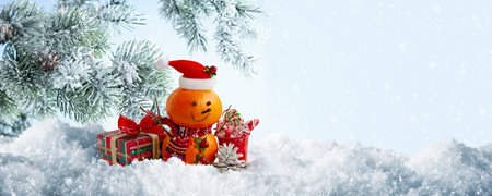 Cute Orange Snowman with Gifts in Winter Snow Sceneの写真素材