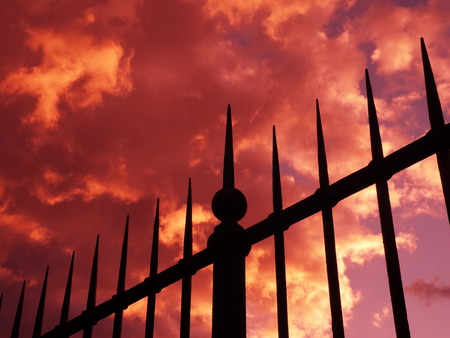 Gate and red stormy sky, Villa Borghese, Romeの写真素材