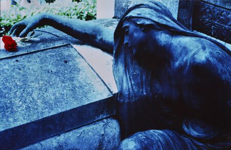 Statue on a grave with pinkの写真素材