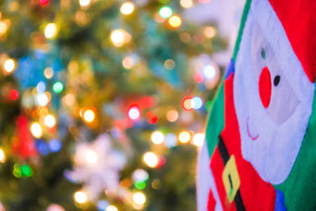 Santa claus and christmas background with defocused lights