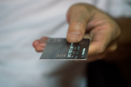 Male hand showing and holding credit cardの写真素材
