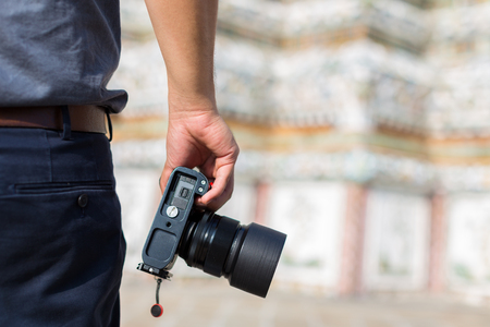 male photographer, hand hold camera, outdoor