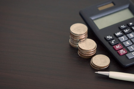 Saving stack coins money concept for Business Finance with pen, calculatorの写真素材