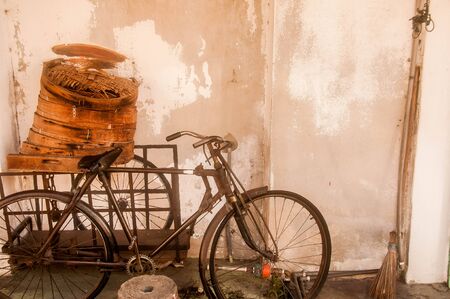 Old bike with cement backgroundの写真素材