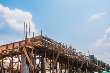 Worker building new house,Wooden Scaffolding surrounded building at construction site,asian styleの写真素材