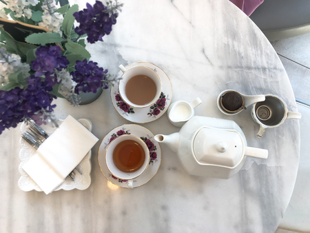 Top view of hot tea with milk and jar,tea break time on marble tableの写真素材