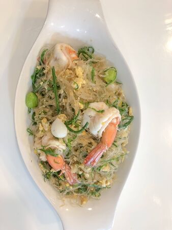 Stir fried vermicelli with pickled garlic,bitter bean,Acacia pennata and sea food,thai foodの写真素材