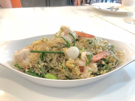 Stir fried vermicelli with pickled garlic,bitter bean,Acacia pennata and sea food,thai foodの写真素材