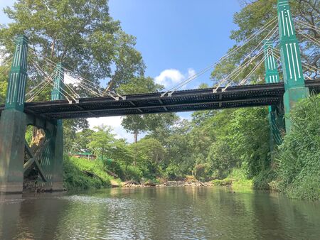 Suspension bridge, Crossing the river with forest and waterfallの写真素材