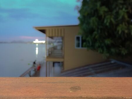 Empty wood bar with blurred river and sunsetの写真素材