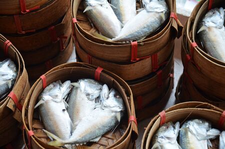 fresh fishes in baskets in thai street marketの写真素材