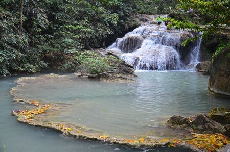 beautiful waterfall and lagoon in Erawan Waterfalls National Park in Thailandの写真素材