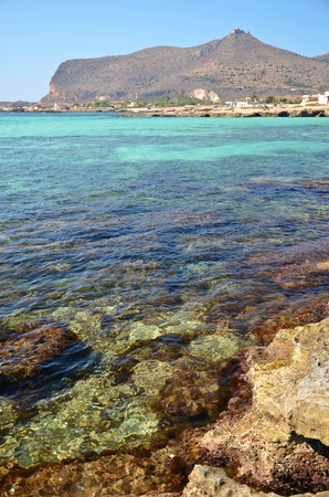 azure blue sea and the castle on a hill on the island of Favignana Italyの写真素材