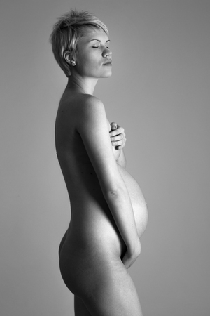 Nude portrait of the young pregnant woman Studio shootの写真素材