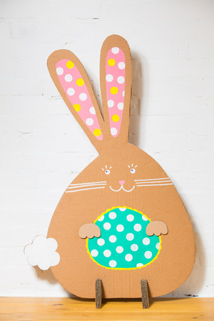 Rabbit made ââfrom organic paper on a white wall. Decoration.の写真素材