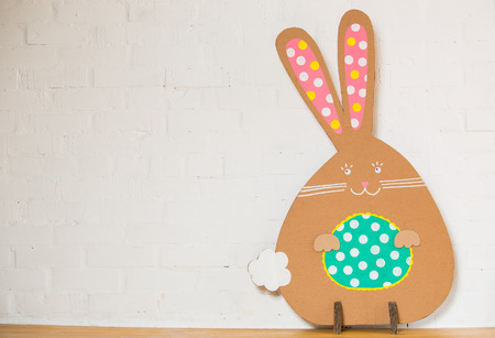 Rabbit made ââfrom organic paper on a white wall. Decoration.の写真素材