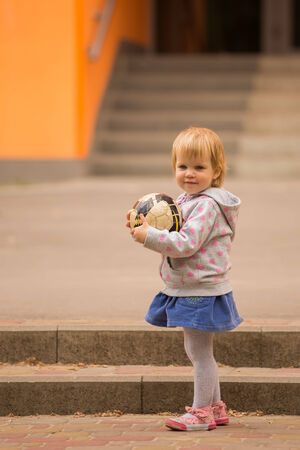 young adorable cheerful baby playing in park in the sunny dayの写真素材