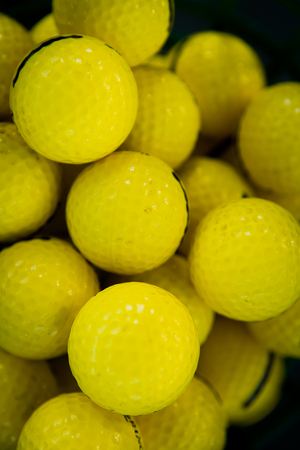 Yellow background. Golf Balls close-upの写真素材
