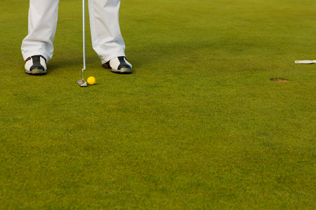 Playing golf. Golf club and ball. Preparing to shot. Backgroundの写真素材