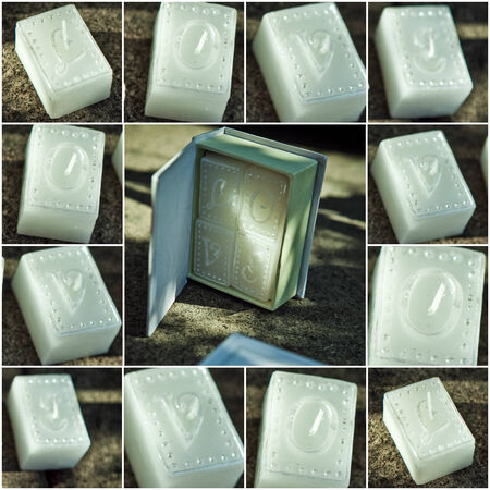 White candles with letters LOVE on a dark background.Collageの写真素材