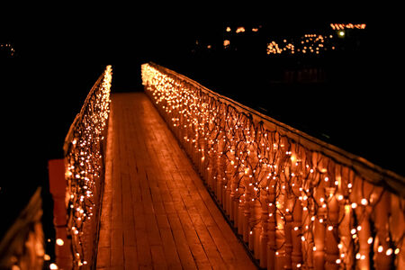 Night wooden bridge with a garland  romantic backgroundの写真素材
