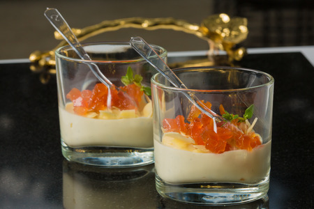Salmon with parmesan cheese and salad in a glass. Catering. close-up