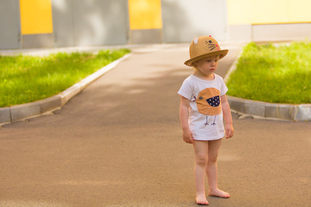 Portrait of a Cute Toddler girl in a funny hat at park backgroundの写真素材