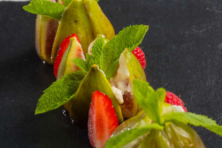 figs with raspberries, served as a dessert, close upの写真素材