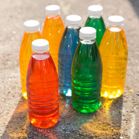 Color, bright creative background  Colored bottles on the pavementの写真素材