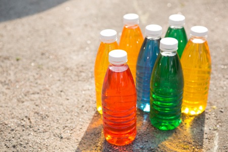 Color, bright creative background  Colored bottles on the pavementの写真素材
