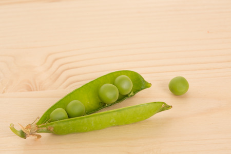 Fresh green peas on a wooden table  Close upの写真素材