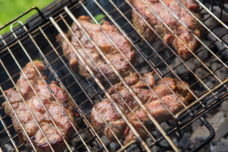 pieces meat char-grilled over flame. food background vegetables char-grilled over flameの写真素材