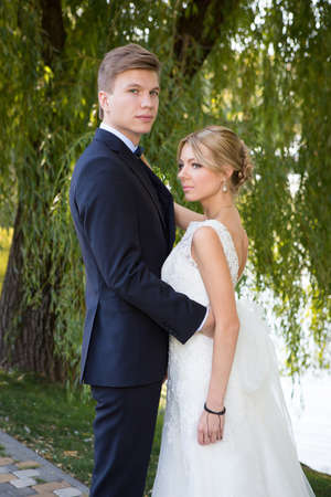 Beautiful wedding couple is enjoying wedding in the sun.の写真素材
