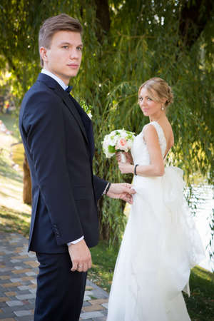 Beautiful wedding couple is enjoying wedding in the sun.の写真素材