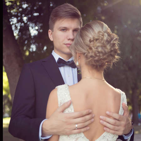 Beautiful wedding couple is enjoying wedding in the sun.の写真素材