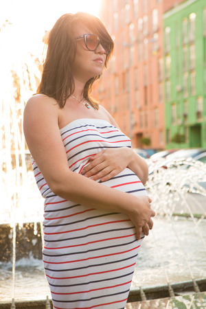 Beautiful pregnant woman relaxing in the parkの写真素材