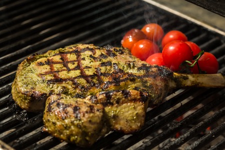 steak flame broiled on a barbecue with vegetables. shallow depth of field.の写真素材